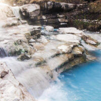 Waterfalls at Diamond Fork Fifth Water Hot Springs Utah | My Local Utah Crystal-clear water flowing over rocks into a turquoise pool at fifth water hot springs surrounded by lush greenery in spanish fork utah My local utah