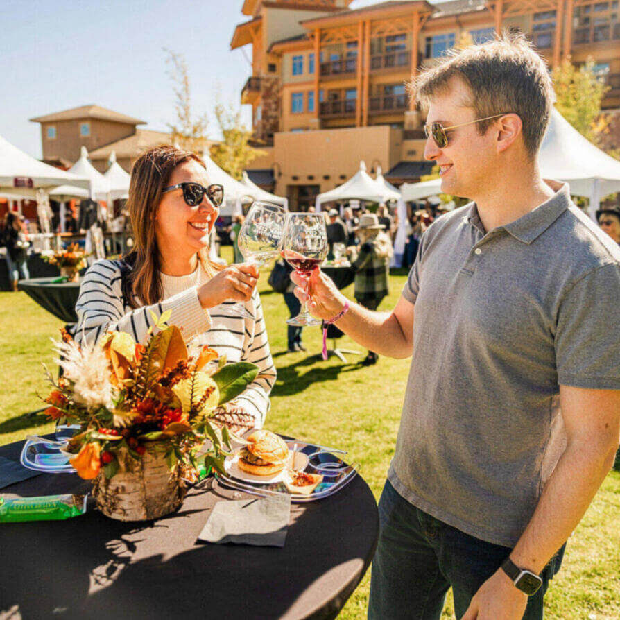 Participants engaging in outdoor activities and wine tasting at the park city wine festival.
