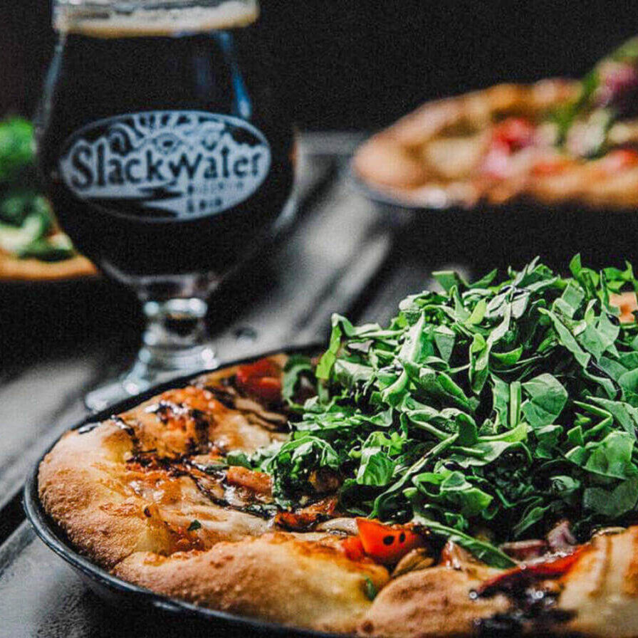 A plate of artisan pizza and craft beer at Slackwater Pizzeria & Pub in Ogden.