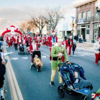 Families dressed in santa costumes running along during the ogden santa run The kids are full of holiday spirit as they join in the fun making this a memorable family event my local utah