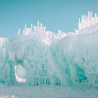Families enjoying the midway ice castles walking through a tunnel of ice My local utah