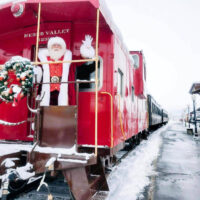 Santa claus getting ready to greet children aboard the north pole express at heber valley railroad filled with holiday decorations Explore my local utah for christmas activities my local utah