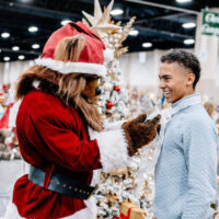 Utah jazz bear interacting with children at the festival of trees event with colorful holiday trees in the background My local utah