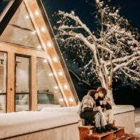 A couple enjoys a peaceful romantic evening in a cozy cabin in the winter Highlighting winter date ideas in utah my local utah