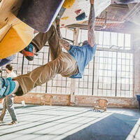 Climbers scaling indoor walls at the front climbing club in ogden utah with a view of the expansive climbing gym My local utah