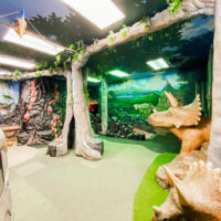 Family enjoying a day at st George children's museum with children participating in an imaginative role-playing exhibit Explore mylocalutah Com for utahs best family activities My local utah