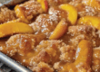 Old time oven peach cobbler freshly baked out the oven on a tray