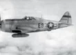 P-47 thunderbolt flying over battlefield in word war two.