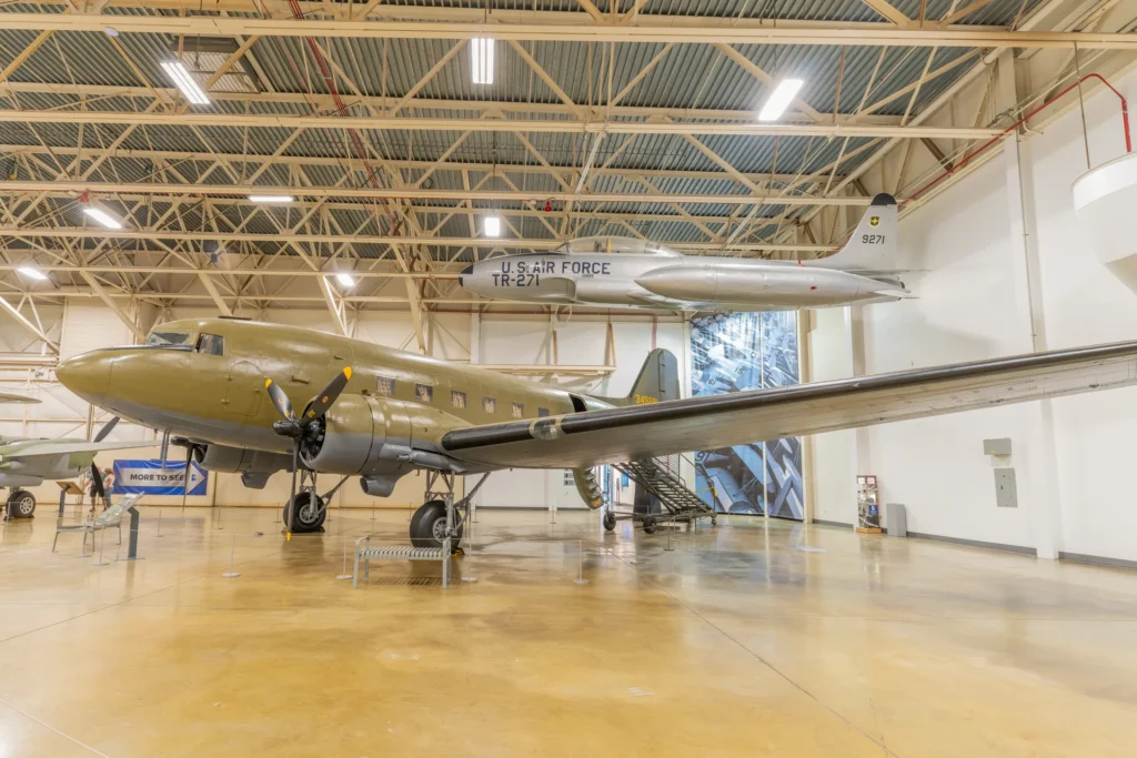 Inside a hill aerospace museum gallery in roy utah with a c-47 skytrain on the floor and a t-33 trainer suspended overhead my local utah my local utah