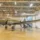 Inside a Hill Aerospace Museum gallery in Roy, Utah, with a C-47 Skytrain on the floor and a T-33 trainer suspended overhead